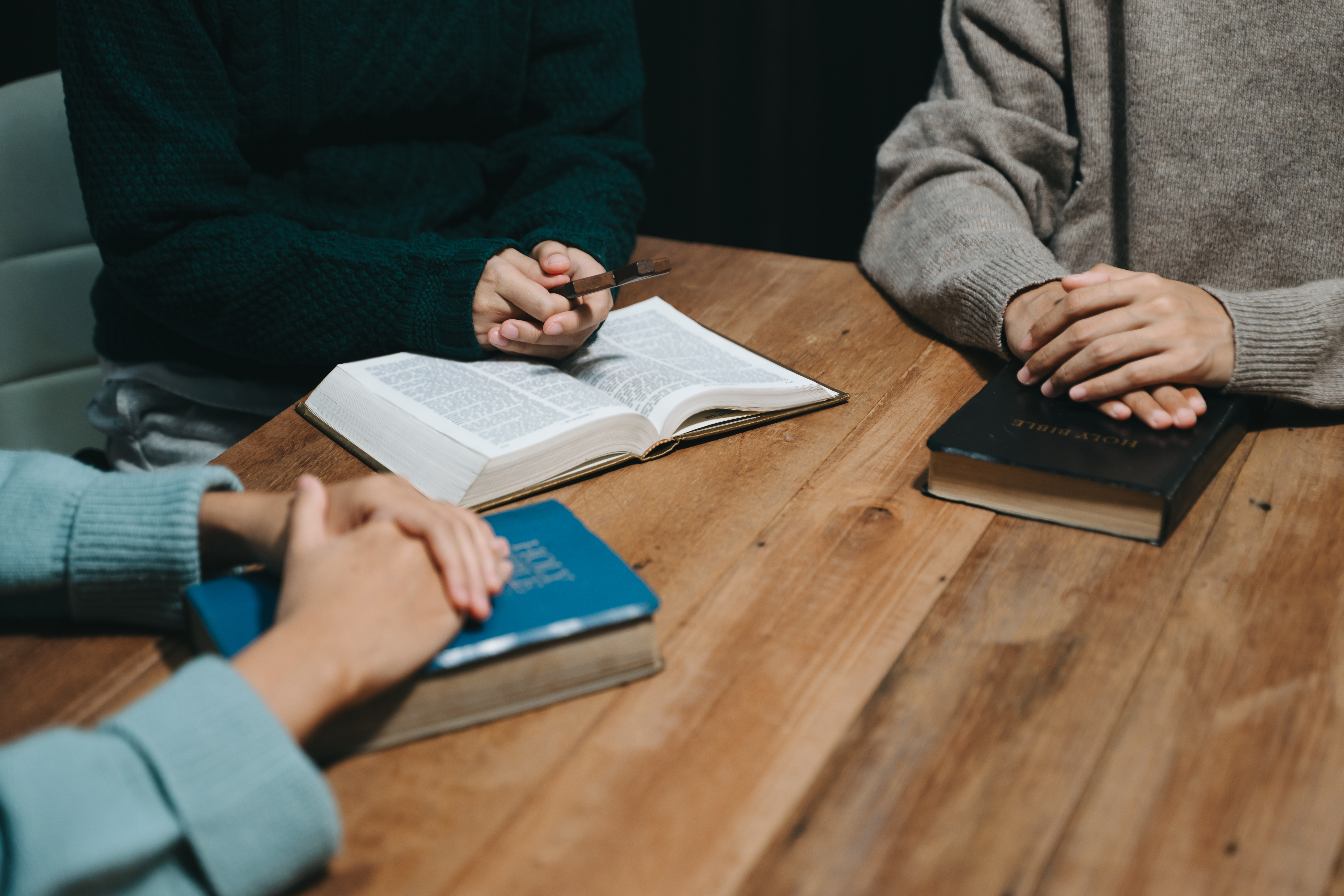 People reading and study bible in home and pray together.Studyi
